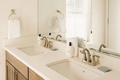 a white bathroom with a sink and a mirror at Lakefront - Trails - Skiing - Views - Georgetown in Georgetown