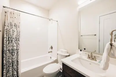 a white bathroom with a sink and a toilet at Lakefront - Trails - Skiing - Views - Georgetown in Georgetown