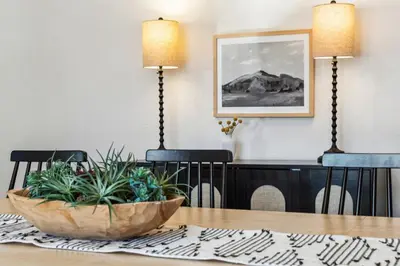 a dining room with a table with plants on it at HotTub - Big Yard - Fireplaces - Games - Fire pit in Arvada