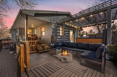 a patio with a couch and a fire pit at HotTub - Big Yard - Fireplaces - Games - Fire pit in Arvada