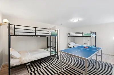 a room with two bunk beds and a ping pong table at HotTub - Big Yard - Fireplaces - Games - Fire pit in Arvada