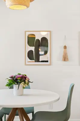 a white dining room table with chairs and a vase of flowers at HotTub - Big Yard - Fireplaces - Games - Fire pit in Arvada