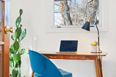 a desk with a laptop and a blue chair at HotTub - Big Yard - Fireplaces - Games - Fire pit in Arvada