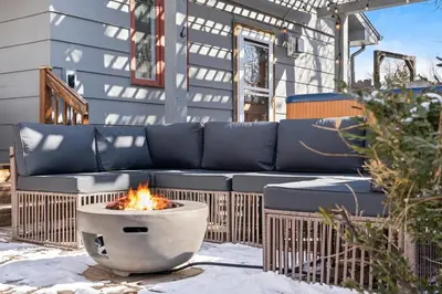 a fire pit sitting on a patio with a couch at HotTub - Big Yard - Fireplaces - Games - Fire pit in Arvada