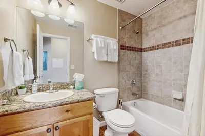 a bathroom with a toilet and a sink and a bath tub at Timbers at the Pines in Fraser