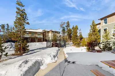 a house with snow on the ground in the yard at Timbers at the Pines in Fraser