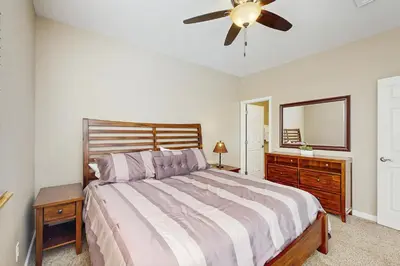 a bedroom with a bed and a ceiling fan at Timbers at the Pines in Fraser