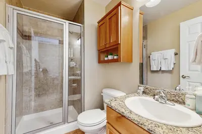 a bathroom with a toilet sink and a shower at Timbers at the Pines in Fraser