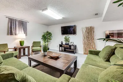 a living room with green couches and a coffee table at Cozy Boulder Basement Unit Upscale Outdoor Space! in Boulder