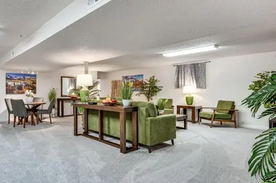 a living room with a green couch and tables and chairs at Cozy Boulder Basement Unit Upscale Outdoor Space! in Boulder
