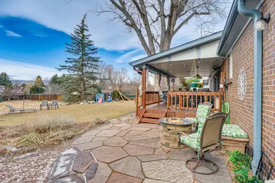 a patio with a table and chairs on a house at Cozy Boulder Basement Unit Upscale Outdoor Space! in Boulder