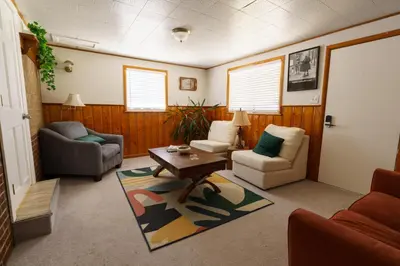 a living room with a couch and a table at Retro 70s Styled Home 15 min to Downtown in Denver