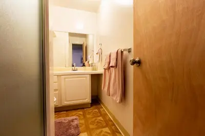 a bathroom with a sink and a mirror at Retro 70s Styled Home 15 min to Downtown in Denver