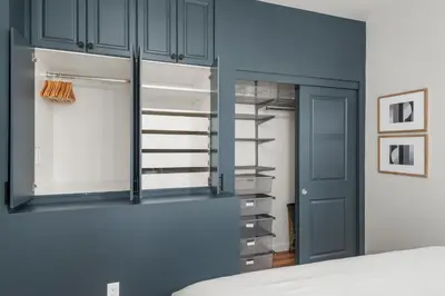 a bedroom with a closet with blue cabinets at Walkable Rooftop Retreat 2BR, Workspace & BBQ in Denver