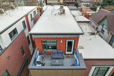 an overhead view of a balcony of a building with chairs at Walkable Rooftop Retreat 2BR, Workspace & BBQ in Denver