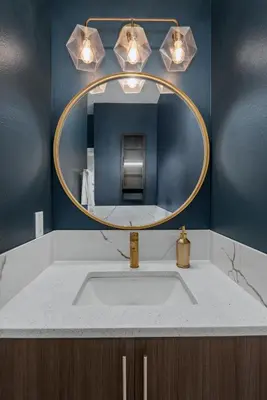 a bathroom with a sink and a mirror at Walkable Rooftop Retreat 2BR, Workspace & BBQ in Denver