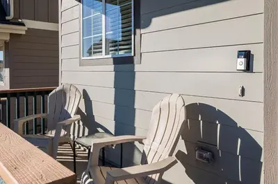 two chairs sitting on a porch next to a building at Family Friendly 5BR Mountain Views & Game Room in Superior