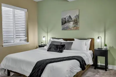 a bedroom with a large white bed and a window at Family Friendly 5BR Mountain Views & Game Room in Superior