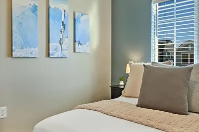 a bedroom with a bed with four pictures on the wall at Family Friendly 5BR Mountain Views & Game Room in Superior