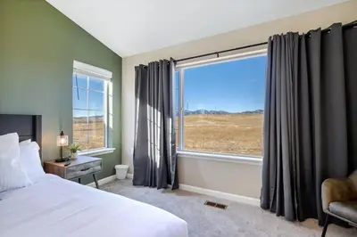 a bedroom with a bed and a large window at Family Friendly 5BR Mountain Views & Game Room in Superior