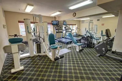 a gym with treadmills and chairs in a room at Gateway Lodge 5008 by SummitCove Lodging in Keystone