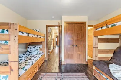 a bedroom with two bunk beds and a couch at 508 Ravenwood A-3 in Grand Lake