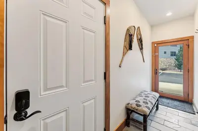 a white door with a stool next to it at 508 Ravenwood A-3 in Grand Lake