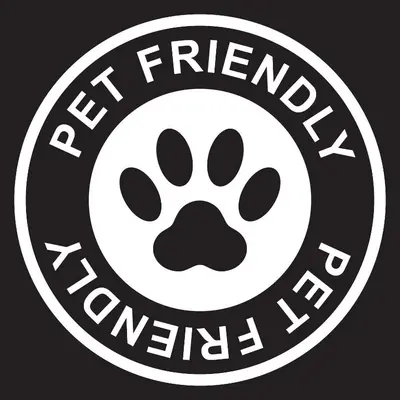 a white dog pawprint stamp with the text trained veterinary at 508 Ravenwood A-3 in Grand Lake