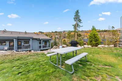 a picnic table in the grass in front of a house at 508 Ravenwood A-3 in Grand Lake