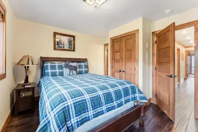 a bedroom with a bed with a cat sitting on it at 508 Ravenwood A-3 in Grand Lake