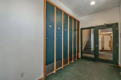 an empty room with a hallway with a glass door at Quicksilver 1674 by SummitCove Lodging in Keystone