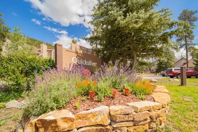 a flower bed in front of a university sign at Quicksilver 1674 by SummitCove Lodging in Keystone