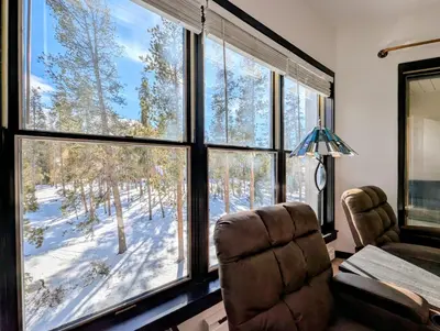 a room with a chair and a window with a view at Quicksilver 1674 by SummitCove Lodging in Keystone
