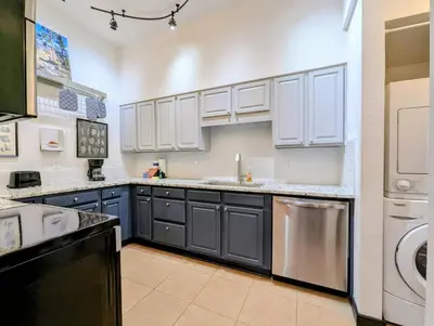 a kitchen with white cabinets and a dishwasher at Quicksilver 1674 by SummitCove Lodging in Keystone