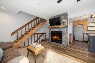 a living room with a fireplace and a tv at Soda Springs Ranch Unit 3C in Grand Lake