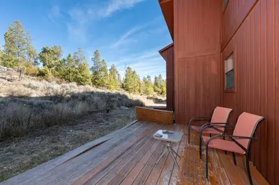 a porch with two chairs and a table on a deck at Soda Springs Ranch Unit 3C in Grand Lake