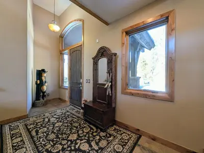 a hallway with a door and a mirror and a window at Keystone Retreat 33 by SummitCove Lodging in Keystone