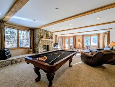 a pool table in a living room with a fireplace at Keystone Retreat 33 by SummitCove Lodging in Keystone