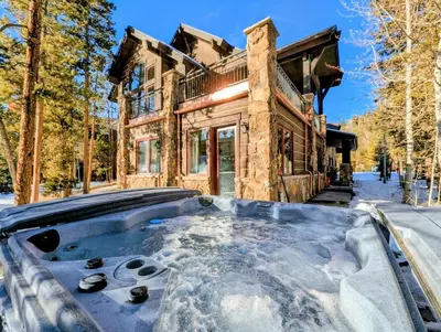 a hot tub in the snow in front of a house at Keystone Retreat 33 by SummitCove Lodging in Keystone