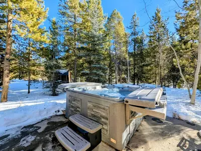 a hot tub in the woods in the snow at Keystone Retreat 33 by SummitCove Lodging in Keystone