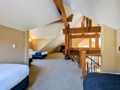 a attic bedroom with two beds and a staircase at Keystone Retreat 33 by SummitCove Lodging in Keystone