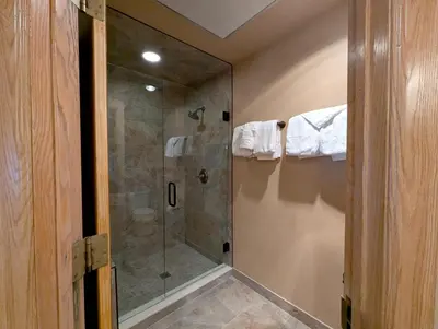 a bathroom with a shower with a glass shower stall at Chateaux DuMont 2710 by SummitCove Lodging in Keystone