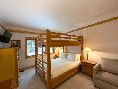 a bedroom with a bunk bed and a couch at Chateaux DuMont 2710 by SummitCove Lodging in Keystone
