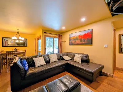 a living room with a leather couch and a table at Flying Dutchman 1132 by SummitCove Lodging in Keystone