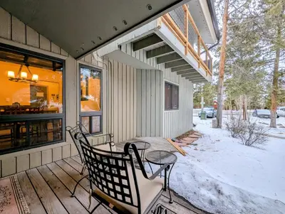 a porch of a house with a table and chairs at Flying Dutchman 1132 by SummitCove Lodging in Keystone