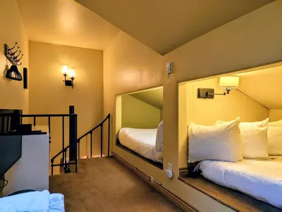 a hotel room with two beds and a mirror at Flying Dutchman 1132 by SummitCove Lodging in Keystone