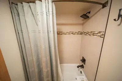 a bathroom with a shower with a shower curtain at Quicksilver 1609 by SummitCove Lodging in Keystone