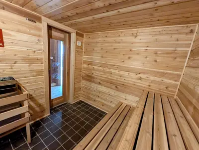 a wooden sauna with a bench in a room at Quicksilver 1609 by SummitCove Lodging in Keystone