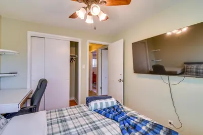 a bedroom with a bed and a table and a desk at 2 Mi to Olde Town! Pet-Friendly Haven with Sunroom in Arvada