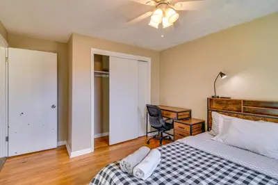 a bedroom with a bed and a desk and a chair at 2 Mi to Olde Town! Pet-Friendly Haven with Sunroom in Arvada